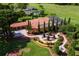 Stunning aerial view of a luxury home featuring a landscaped yard, pool, and tile roof at 5235 Greens Dr, Lady Lake, FL 32159