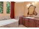 A luxurious bathroom features a soaking tub, custom vanities, and a stylish, relaxing atmosphere at 5235 Greens Dr, Lady Lake, FL 32159