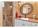 Beautiful bathroom features an updated vanity, large mirror and walk-in shower at 5235 Greens Dr, Lady Lake, FL 32159