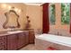 This bathroom offers elegant fixtures, custom cabinetry, and a soaking tub for a spa-like retreat at 5235 Greens Dr, Lady Lake, FL 32159