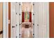 The luxurious bathroom has a chandelier over the soaking tub and views of the backyard at 5235 Greens Dr, Lady Lake, FL 32159