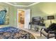 Bright bedroom with TV, ceiling fan, and a doorway leading to another room at 5235 Greens Dr, Lady Lake, FL 32159