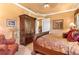 Comfortable bedroom showcases a decorative wardrobe, plush furnishings, and a cozy ambiance at 5235 Greens Dr, Lady Lake, FL 32159