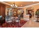Elegant dining room featuring a chandelier, a view of the kitchen, and access to outdoor living at 5235 Greens Dr, Lady Lake, FL 32159