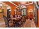 Formal dining room features a large table, ornate chandelier, and elegant decor at 5235 Greens Dr, Lady Lake, FL 32159