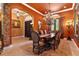 Elegant dining room with a long table, ornate chandelier, and arched entryway at 5235 Greens Dr, Lady Lake, FL 32159