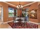 This dining area offers views of the pool, patio access, and a stylish chandelier at 5235 Greens Dr, Lady Lake, FL 32159