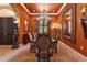 Ornate dining room with a large wooden table, chandelier, and warm, inviting colors at 5235 Greens Dr, Lady Lake, FL 32159