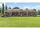 Expansive screened-in lanai with statues and beautiful landscaping on a lush green lawn at 5235 Greens Dr, Lady Lake, FL 32159