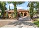 Exterior of the house with a tile roof, arched entryway, and well-maintained landscaping at 5235 Greens Dr, Lady Lake, FL 32159