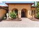 Stunning front entrance with arched doorways, stone walkway, and manicured landscaping exudes curb appeal at 5235 Greens Dr, Lady Lake, FL 32159