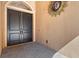 Close-up of the front doors with a sun decoration on the wall at 5235 Greens Dr, Lady Lake, FL 32159