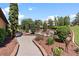 Well-manicured garden featuring a fountain, lush greenery, and winding brick pathways and bronze statue at 5235 Greens Dr, Lady Lake, FL 32159