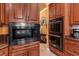 This kitchen features stainless steel appliances, custom wood cabinets, and an attached breakfast nook at 5235 Greens Dr, Lady Lake, FL 32159