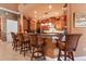 Open concept kitchen featuring bar seating, pendant lighting, and custom wood cabinetry at 5235 Greens Dr, Lady Lake, FL 32159
