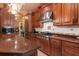 Gourmet kitchen features custom wood cabinetry, a stainless steel range hood, and a gas cooktop at 5235 Greens Dr, Lady Lake, FL 32159