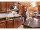 Gourmet kitchen showcases wood cabinets, stainless steel appliances, and a spacious center island at 5235 Greens Dr, Lady Lake, FL 32159