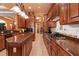 Open kitchen features a large island, stainless appliances, stylish lighting, and custom cabinetry at 5235 Greens Dr, Lady Lake, FL 32159