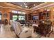 Spacious living room with comfortable seating, built-in shelving, and a view to the outside at 5235 Greens Dr, Lady Lake, FL 32159