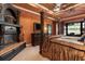 Elegant main bedroom boasts a fireplace, canopy bed, and access to outdoor living space at 5235 Greens Dr, Lady Lake, FL 32159