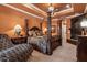 The main bedroom boasts a four poster bed, cozy chaise, and custom fireplace at 5235 Greens Dr, Lady Lake, FL 32159