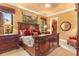 Elegant main bedroom features a decorative headboard, luxe bedding, and ample natural light at 5235 Greens Dr, Lady Lake, FL 32159