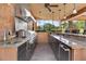 Outdoor kitchen with stainless steel appliances, granite countertops, and ample storage at 5235 Greens Dr, Lady Lake, FL 32159