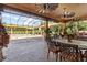 Spacious outdoor living area with a pool, covered patio, and golf course views at 5235 Greens Dr, Lady Lake, FL 32159