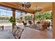 Covered patio with comfortable seating and view of the pool and the backyard at 5235 Greens Dr, Lady Lake, FL 32159