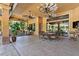 Covered patio features outdoor seating, ceiling fans, and a view of the backyard at 5235 Greens Dr, Lady Lake, FL 32159