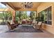 Covered patio features comfortable seating with views of the beautifully landscaped yard at 5235 Greens Dr, Lady Lake, FL 32159