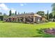 Screened-in pool area with decorative horse statue, greenery, and manicured lawn at 5235 Greens Dr, Lady Lake, FL 32159
