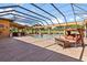 Screened-in pool area with covered patio, lounge chair, and view of the golf course at 5235 Greens Dr, Lady Lake, FL 32159