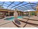 Beautiful pool area includes a screen enclosure, tile work, and unique statue decor at 5235 Greens Dr, Lady Lake, FL 32159