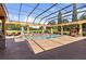 Stunning backyard oasis boasts a luxurious pool, screened enclosure, and meticulous landscaping at 5235 Greens Dr, Lady Lake, FL 32159