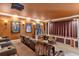 Comfortable home theater room with tiered seating, a projector, and movie memorabilia at 5235 Greens Dr, Lady Lake, FL 32159