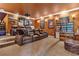 Home theater with tiered seating, a projector screen, and cozy leather recliners at 5235 Greens Dr, Lady Lake, FL 32159