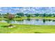 Picturesque backyard view of a tranquil pond surrounded by lush greenery, showcasing Florida nature at 5412 County Road 125, Wildwood, FL 34785