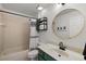 Bathroom with a shower-tub combination, tile walls, and a vanity with a green cabinet and light countertop at 5412 County Road 125, Wildwood, FL 34785