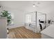 Bright bedroom with four-poster bed, minimalist decor, and natural light streaming through the window at 5412 County Road 125, Wildwood, FL 34785