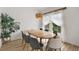 Elegant dining room with a wooden table, stylish chairs, and a large window providing natural light at 5412 County Road 125, Wildwood, FL 34785