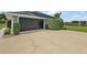 Spacious two-car garage featuring well-maintained driveway with mature landscaping at 5412 County Road 125, Wildwood, FL 34785