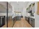 Contemporary kitchen with stainless steel appliances, gray cabinetry, and an island, designed for both cooking and entertaining at 5412 County Road 125, Wildwood, FL 34785
