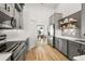 Modern kitchen with sleek gray cabinets, stainless steel appliances, and hardwood floors, offering a stylish and functional space at 5412 County Road 125, Wildwood, FL 34785