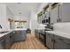 Well-appointed kitchen featuring gray cabinets, a subway tile backsplash, and hardwood floors, combining elegance with functionality at 5412 County Road 125, Wildwood, FL 34785