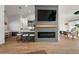 Open concept living space with modern fireplace, kitchen island, and dining area, perfect for entertaining at 5412 County Road 125, Wildwood, FL 34785