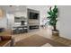 Stylish living area featuring a fireplace, kitchen island with seating, and a dining area in an open concept layout at 5412 County Road 125, Wildwood, FL 34785