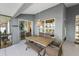 Covered patio showcases a dining area with wicker chairs and table, creating a cozy space for outdoor meals at 5412 County Road 125, Wildwood, FL 34785