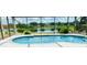 Stunning screened-in pool overlooking a peaceful lake, ideal for outdoor relaxation and entertaining guests at 5412 County Road 125, Wildwood, FL 34785