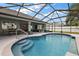 Captivating screened-in pool area with outdoor seating, perfect for enjoying the beautiful water and surrounding views at 5412 County Road 125, Wildwood, FL 34785
